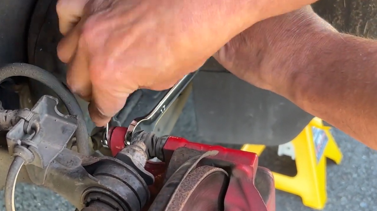 Loosen and remove the brake caliper mounting bolts Removing the brake caliper mounting bolts
