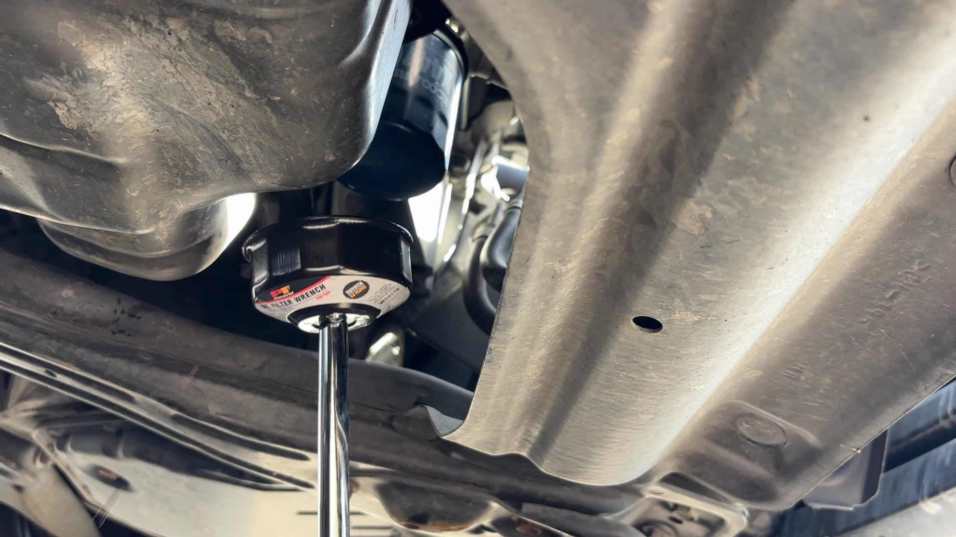 Removing the oil filter from the engine, and be ready for oil to spill from the filter.
